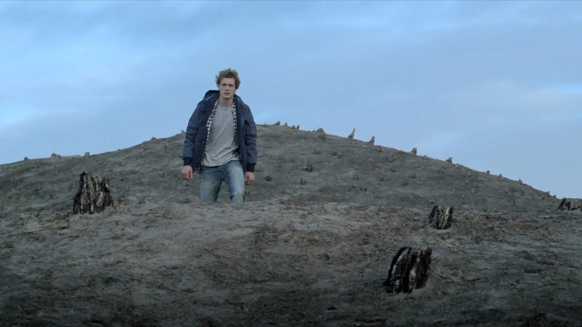 A young man alone on a bare dune, in The Good Life