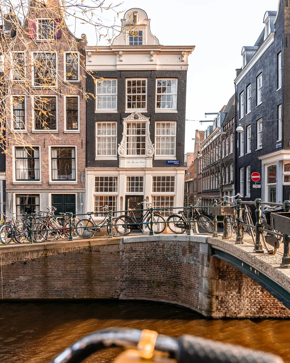 Canal houses and a bridge with bicycles on the Bloemgracht