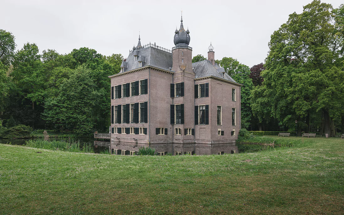 A country house with a lawn and trees