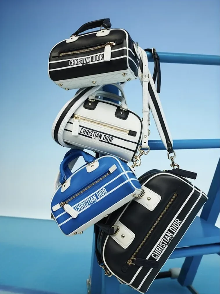 Four Dior Vibe bags hanging from the rink barrier