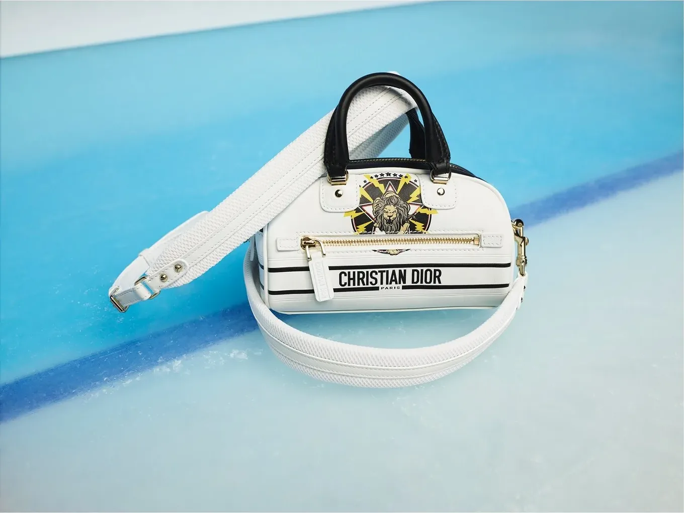 White Christian Dior bag lying on the blue ice