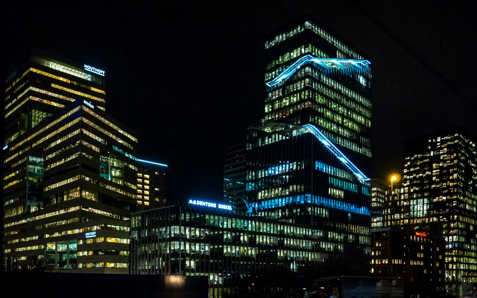Lit office towers on the Zuidas at night