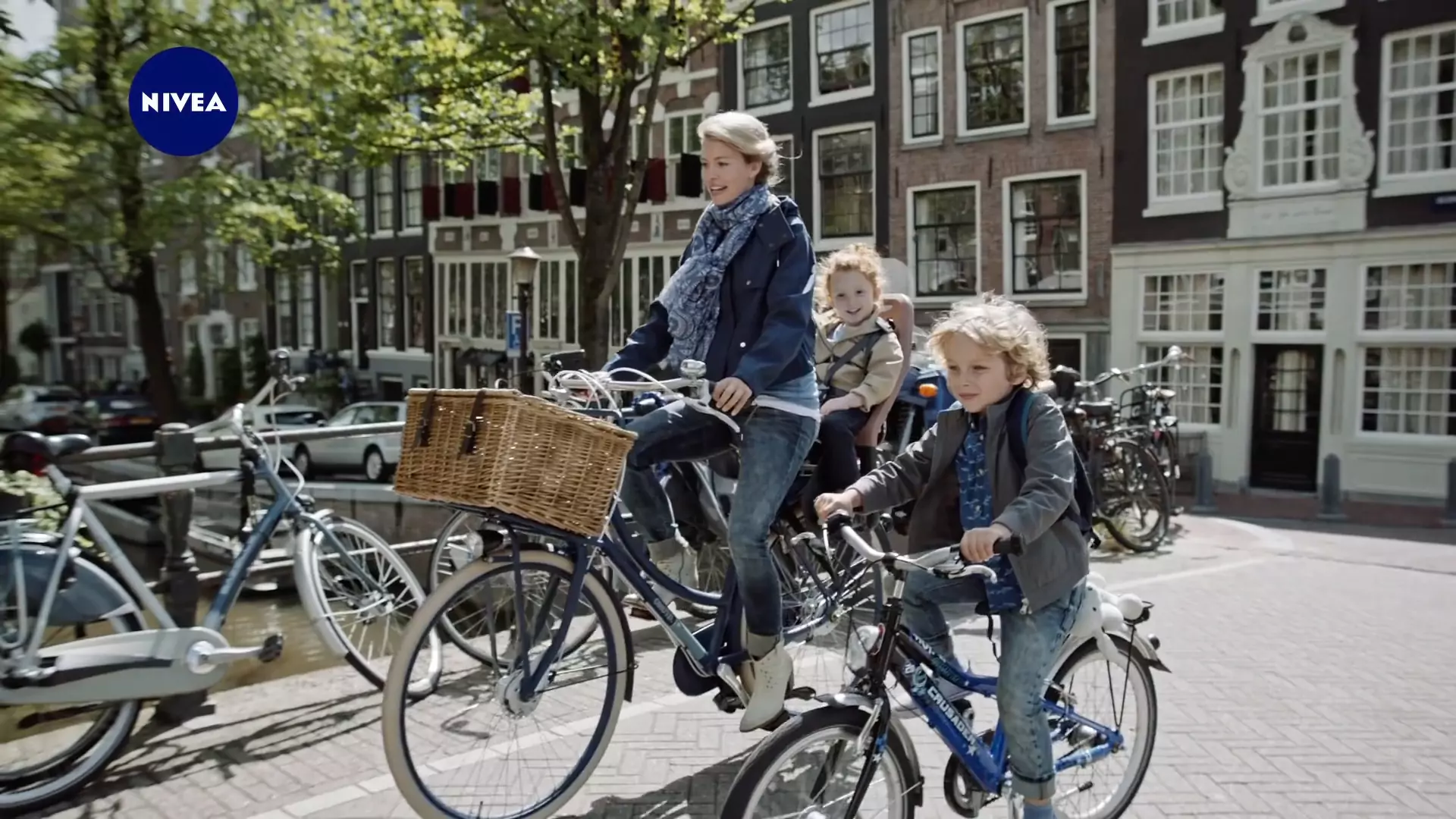 Still from the Nivea film, a family cycling along an Amsterdam canal