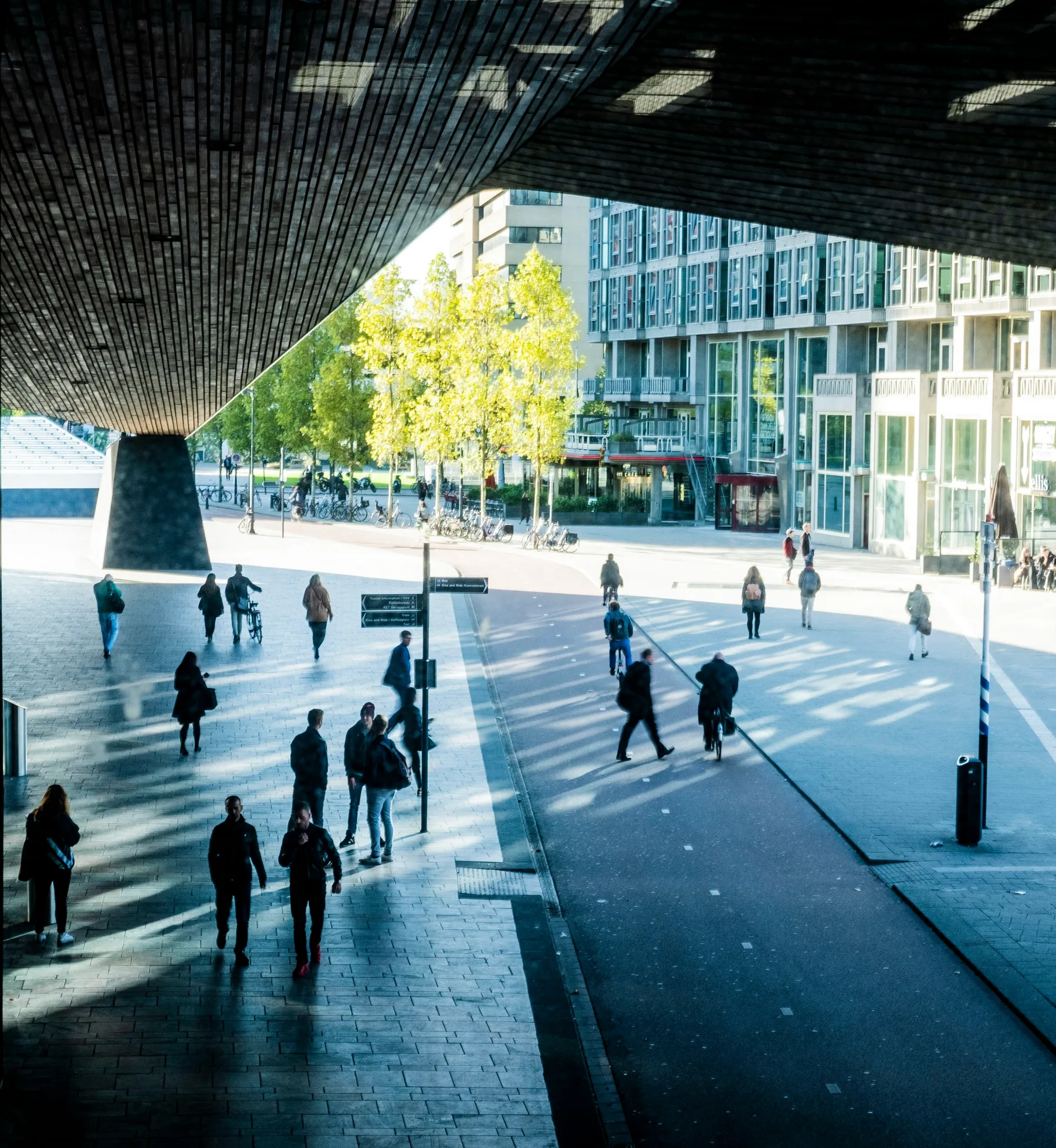 People walking under the roof of Rotterdam Centraal
