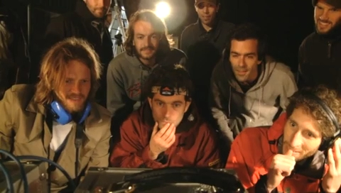 The crew crowd round the monitors at night, waiting for the rooster