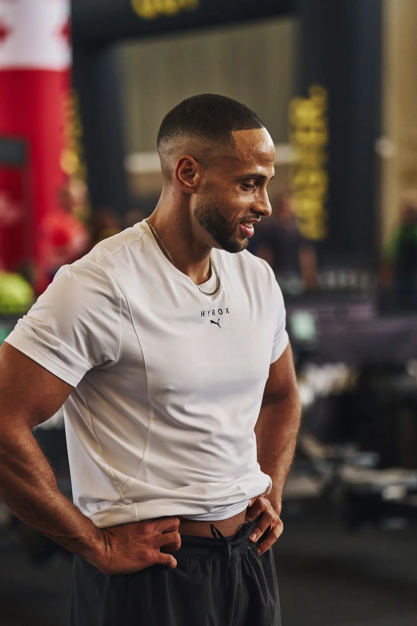 Athlete in a white PUMA Hyrox shirt catching his breath
