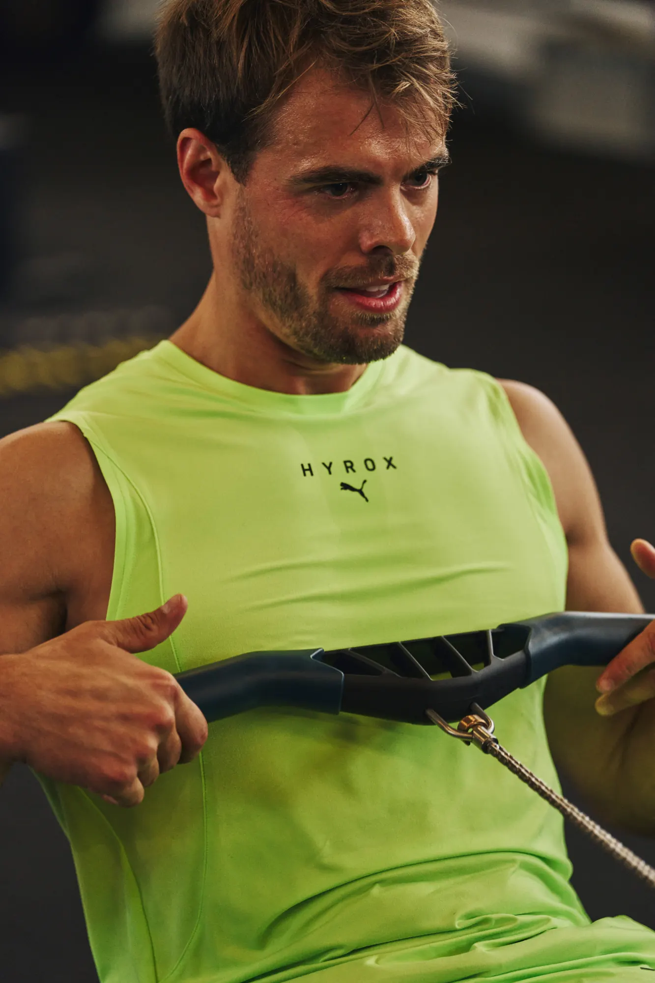 Athlete in a neon PUMA top on the rowing machine