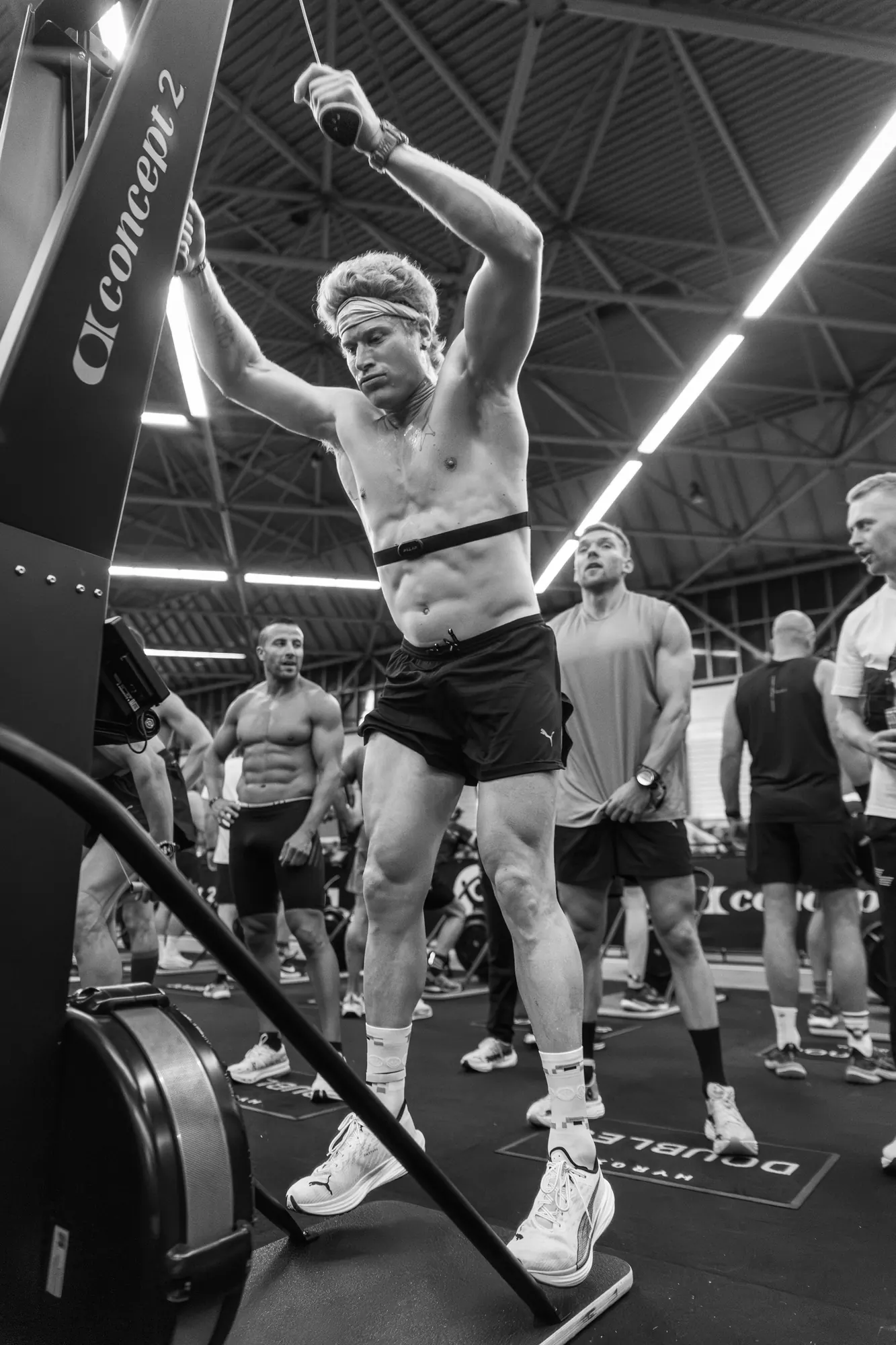Athlete on the SkiErg in front of the crowd at the Hyrox race