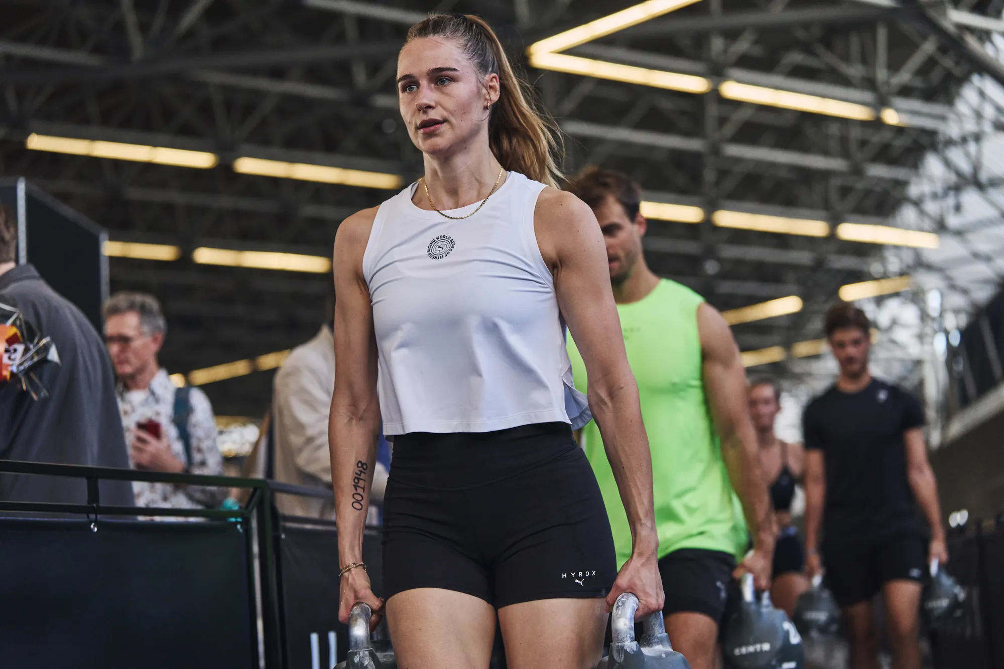 Athletes walking with kettlebells in the RAI hall