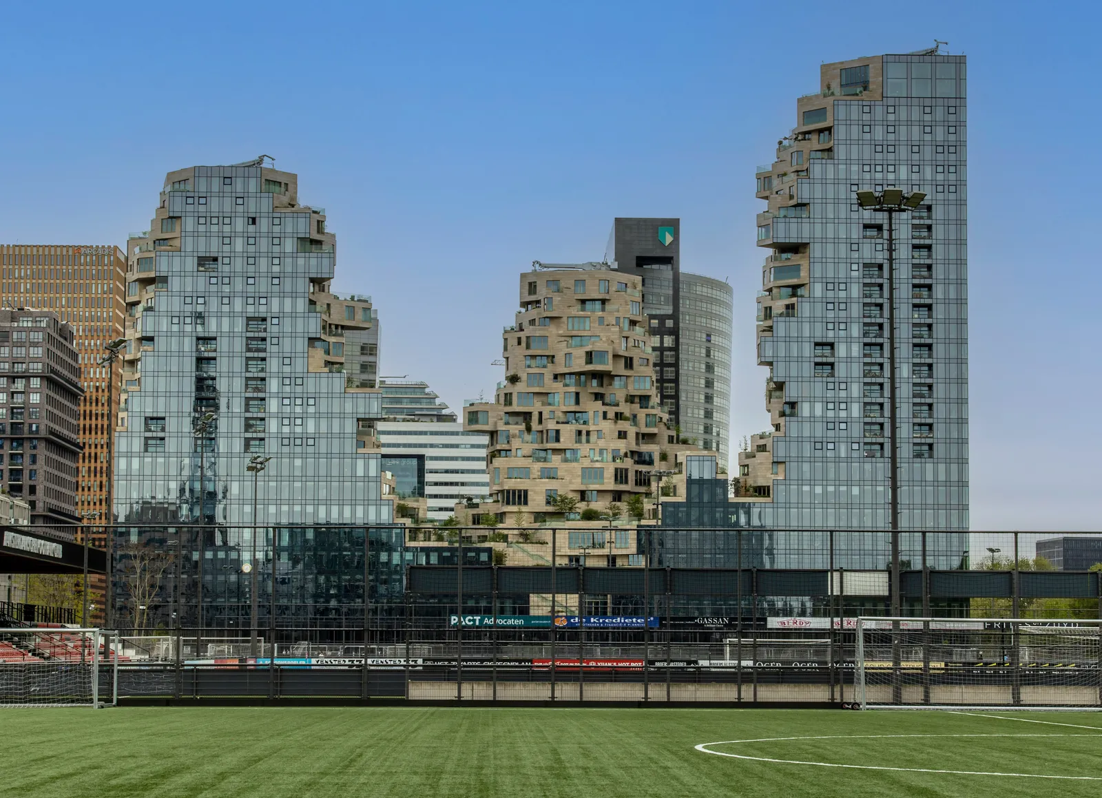 The Zuidas towers behind a football pitch